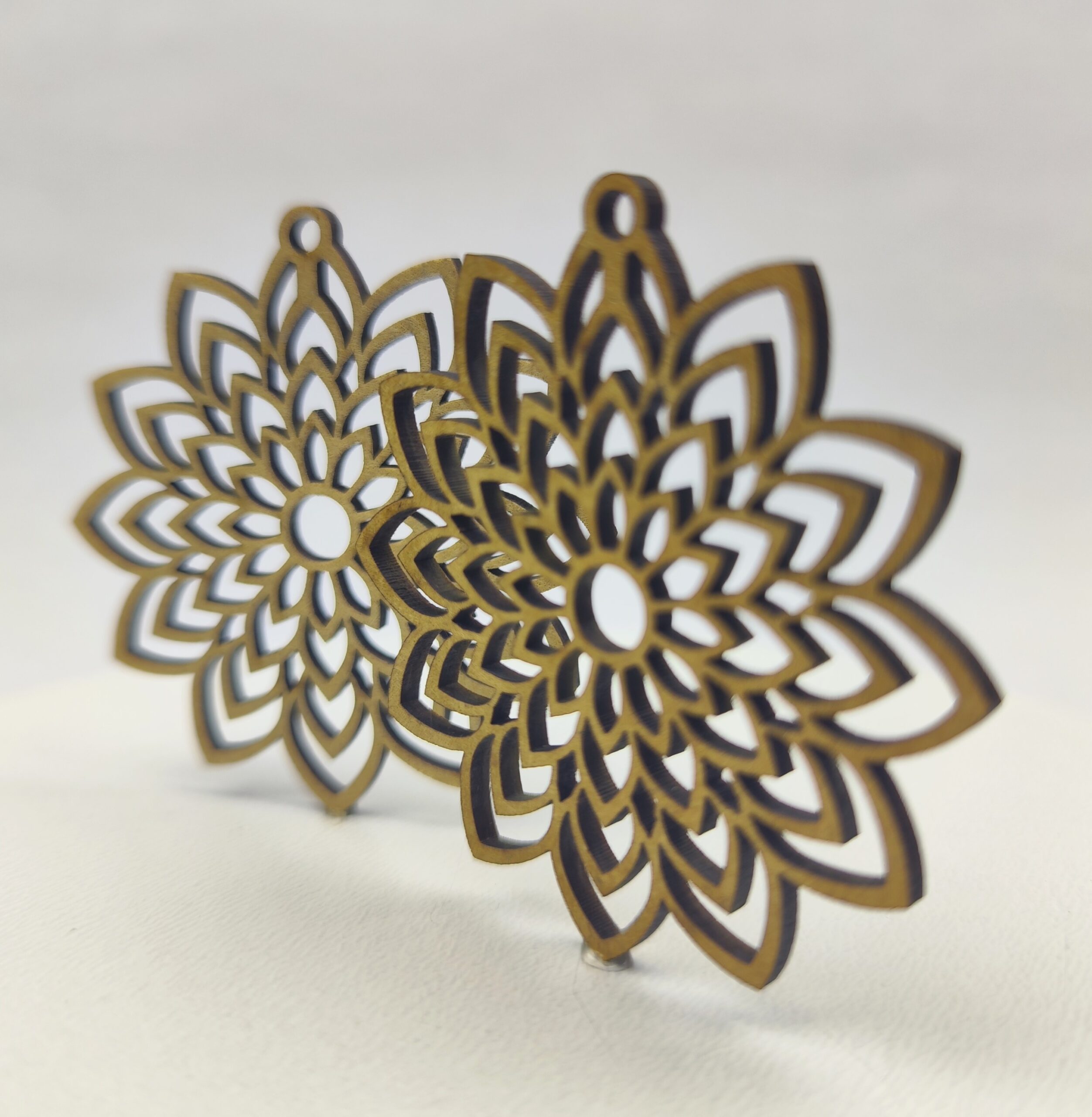 Drewniana baza do kolczyków w kształcie misternej rozety, ażurowy wzór mandali.